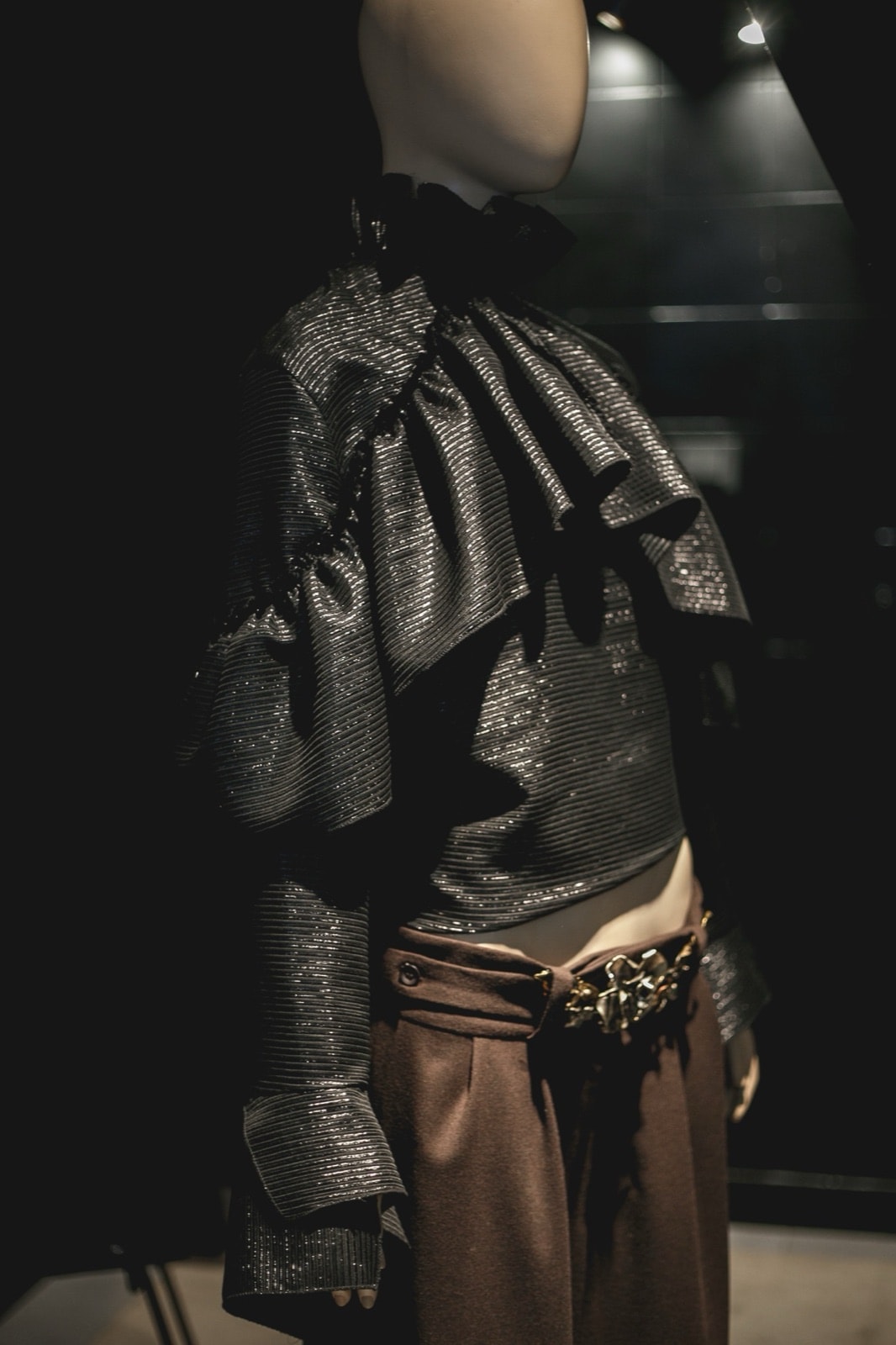 Blusa Olé! Negra Texturizada sobre maniquí, vista de perfil que muestra la caída de los volados en la manga.