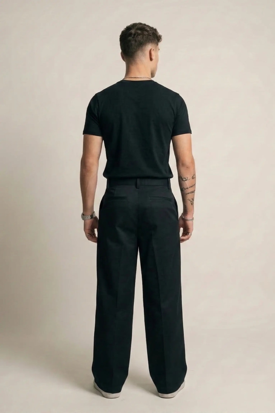 Pantalón Sastrero Molina negro de pierna ancha, vista de espalda sobre modelo, con la pretina y los bolsillos traseros.