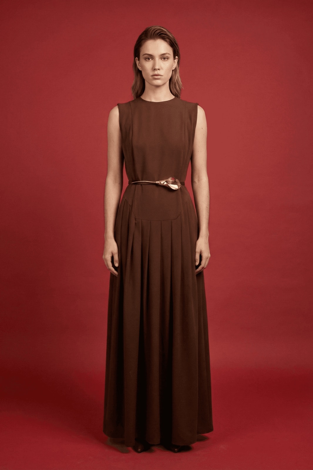Vestido Chocolate con Tablas y Cinturón Cala sobre modelo de cuerpo entero, vista frontal en crepe sastrero color chocolate.