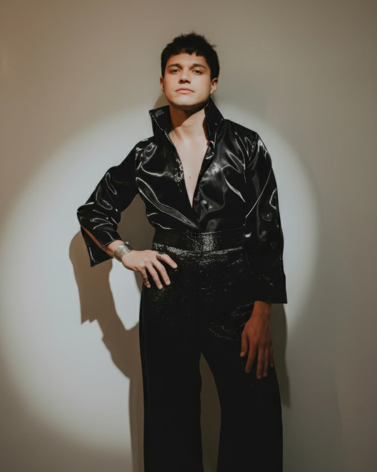 Alan Lez in a black satin shirt and sequinned trousers by Atelier Molina