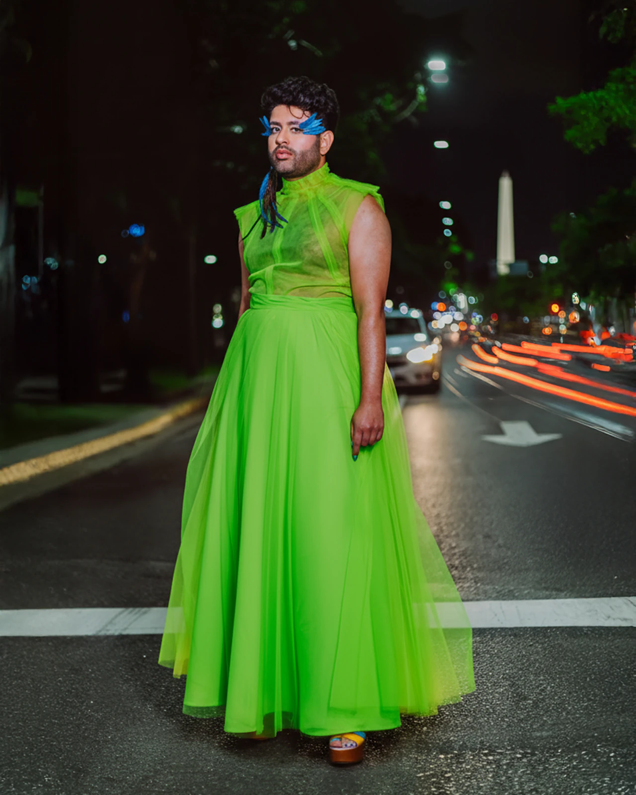 Alok V Menon in the green tulle gown by Atelier Molina on Avenida 9 de Julio, with the Buenos Aires Obelisk behind