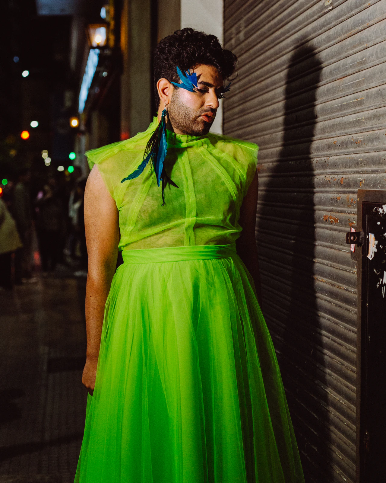 Alok V Menon with arms crossed in the green tulle gown by Atelier Molina on a Buenos Aires street