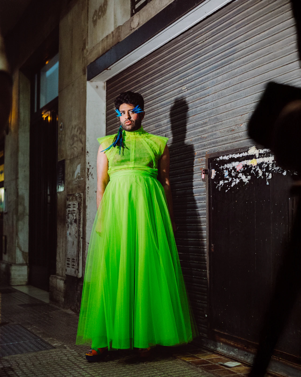 Alok V Menon in the green tulle gown by Atelier Molina on a Buenos Aires sidewalk at night