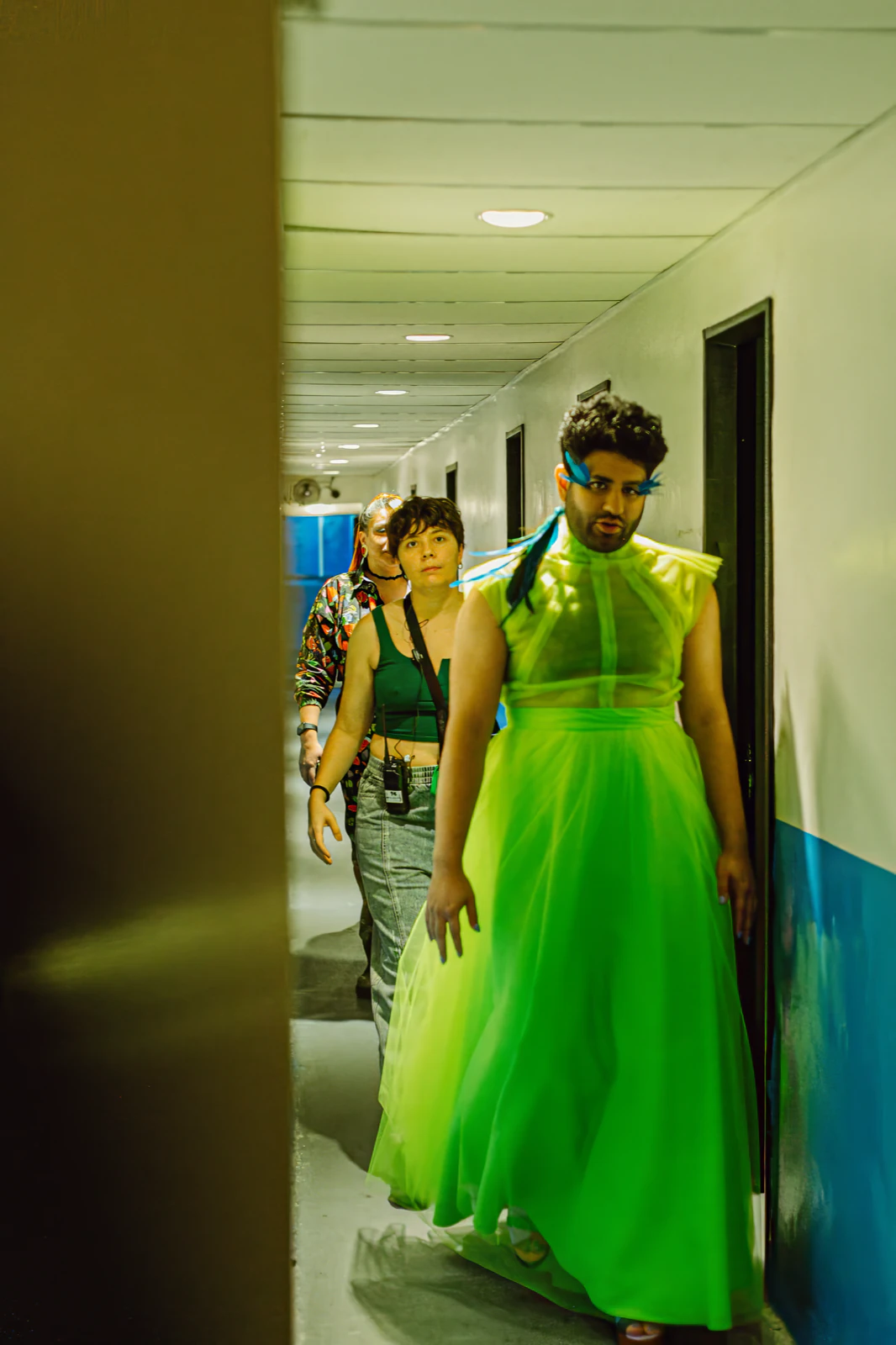 Alok V Menon walking down the corridor to the stage in the green tulle gown by Atelier Molina